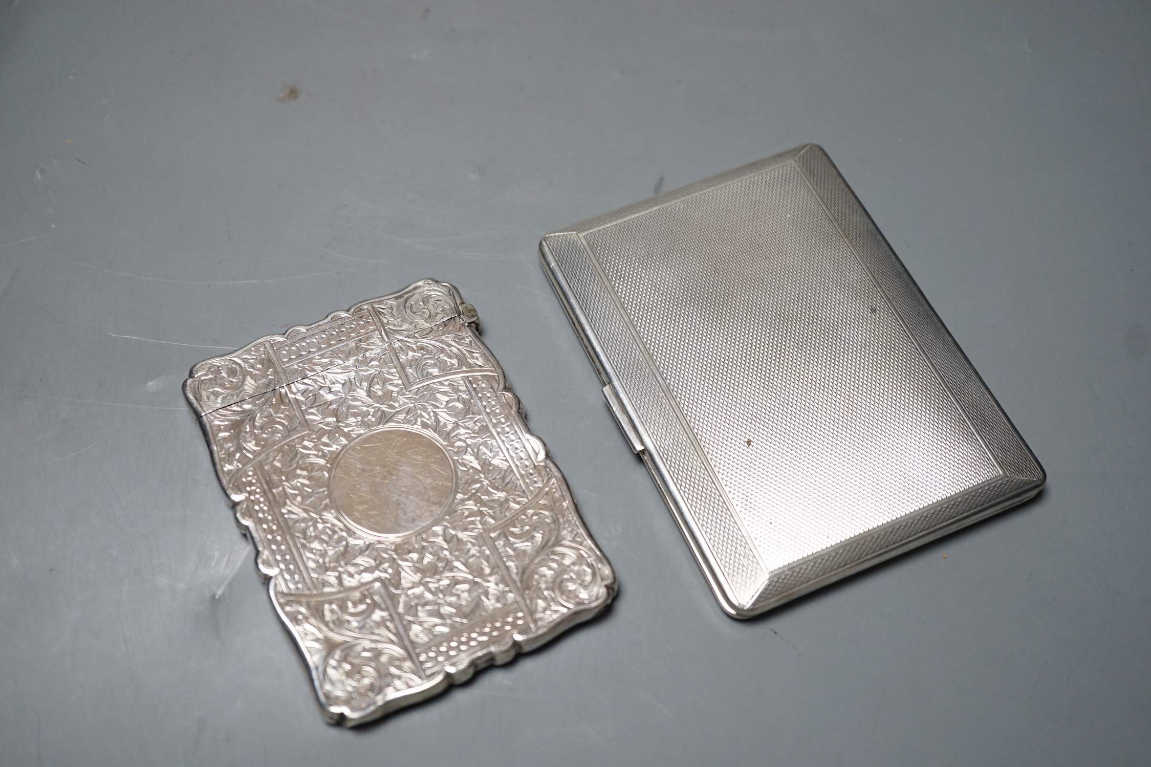 A late Victorian engraved silver calling card case, Birmingham, 1892, 98mm, and a George V engine turned cigarette case.